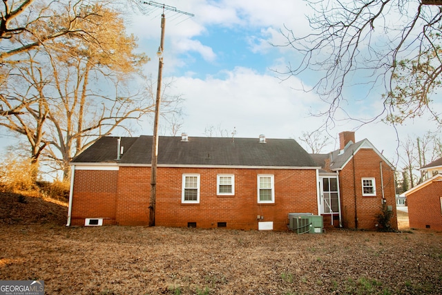 603 E Main St, Thomaston, GA 30286 - back of property with crawl space, brick siding, a chimney, and cooling unit