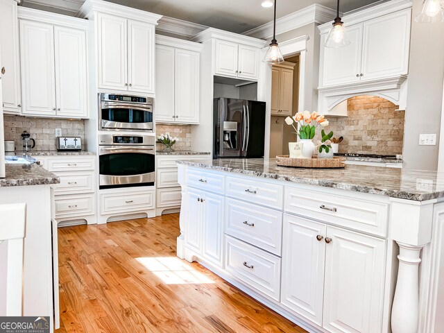 kitchen with light wood-style floors, backsplash, white cabinets, and fridge with ice dispenser