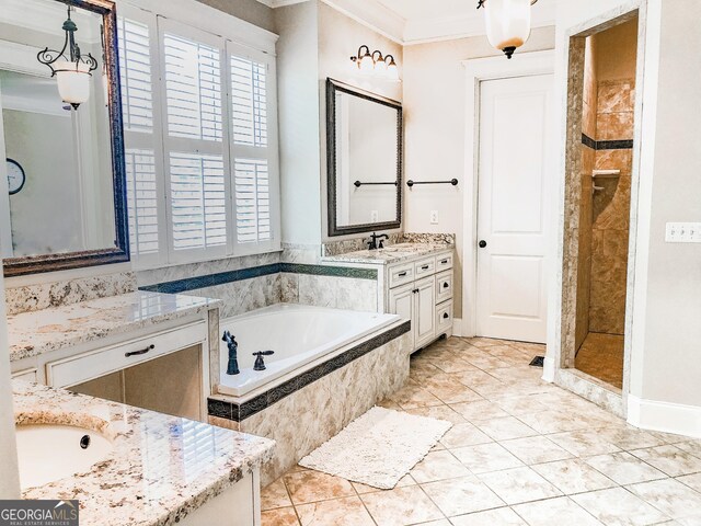 full bathroom featuring crown molding, a garden tub, two vanities, tile patterned floors, and a sink