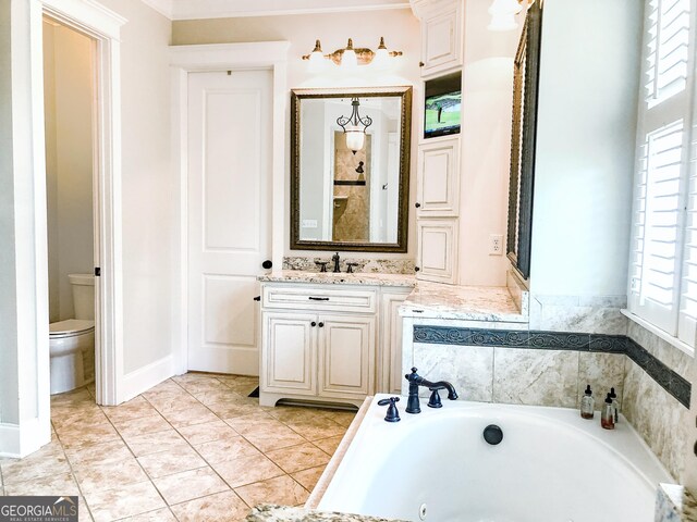 full bath featuring vanity, toilet, crown molding, and a jetted tub