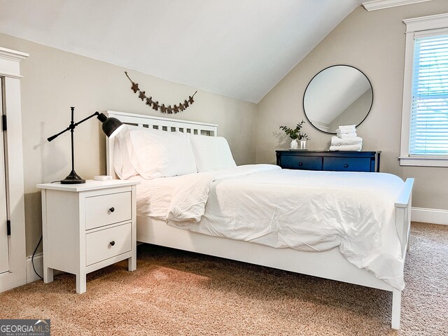 bedroom featuring light colored carpet, multiple windows, and lofted ceiling