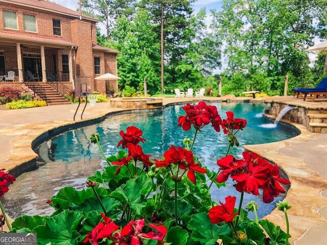 pool featuring a patio area and stairway