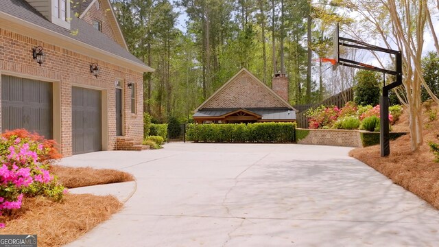 view of patio / terrace featuring a garage and concrete driveway