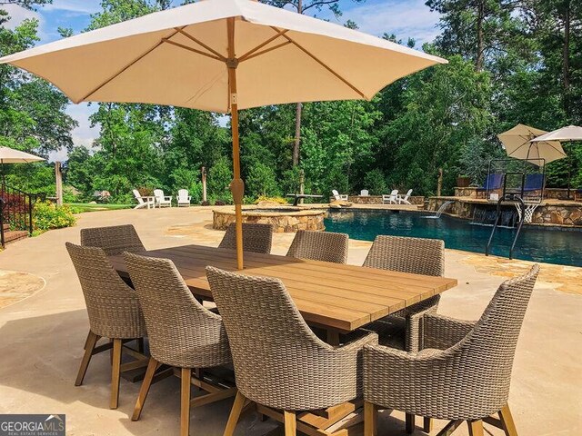 view of patio with an outdoor pool and outdoor dining space