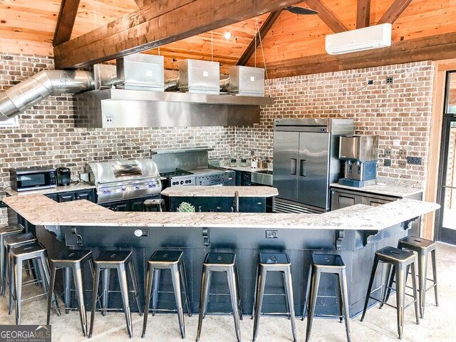 kitchen with wood ceiling, lofted ceiling with beams, stainless steel appliances, and a wall unit AC