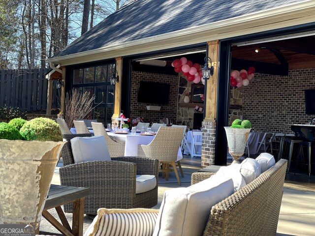 view of patio / terrace with fence, outdoor dining space, and an outdoor hangout area