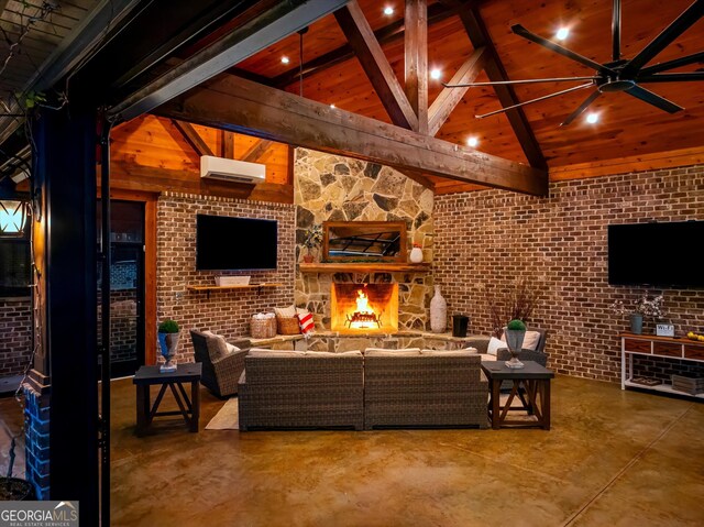 living room with finished concrete flooring, a wall unit AC, a stone fireplace, and beam ceiling