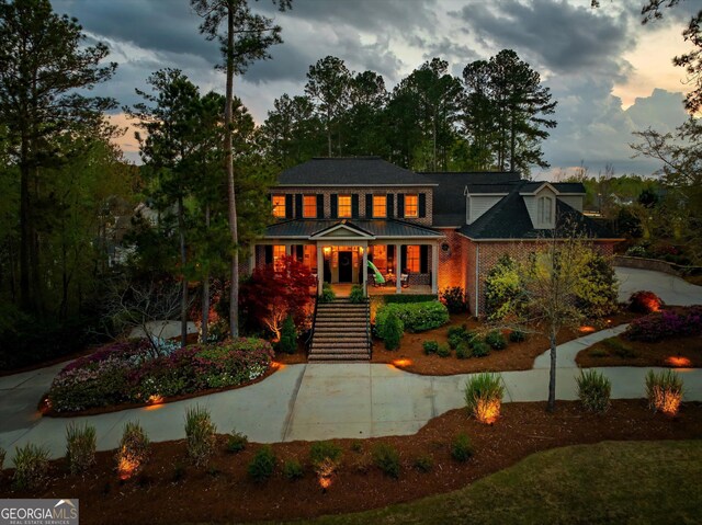 view of front of property with a porch and stairway