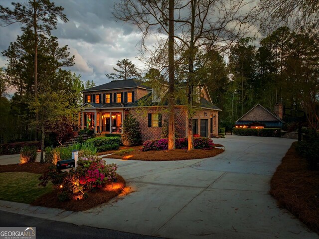 view of front of house featuring a garage, driveway, and brick siding