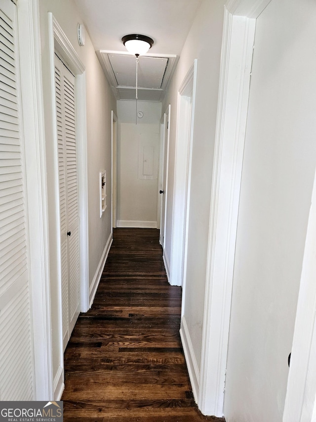 hallway featuring attic access and dark wood finished floors