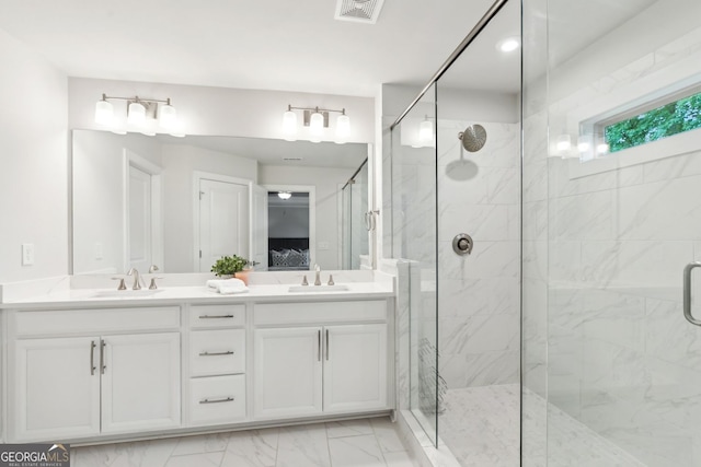 bathroom with visible vents, a sink, marble finish floor, and a stall shower