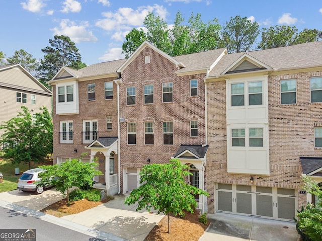 view of building exterior with driveway and a garage