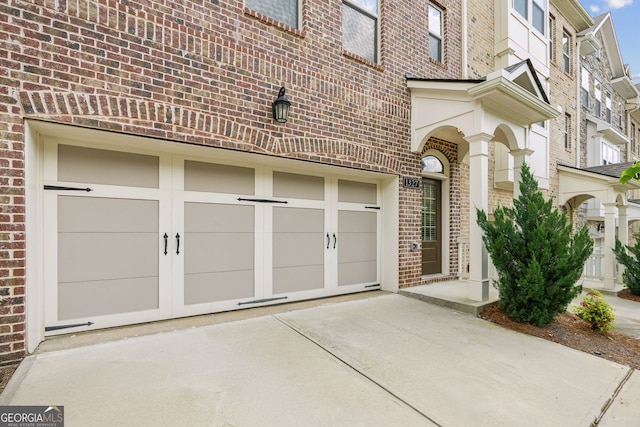 garage featuring concrete driveway