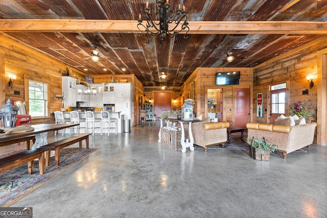 290 Weldon Rd, Fayetteville, GA 30215 - living room featuring wood walls, a chandelier, and a wealth of natural light