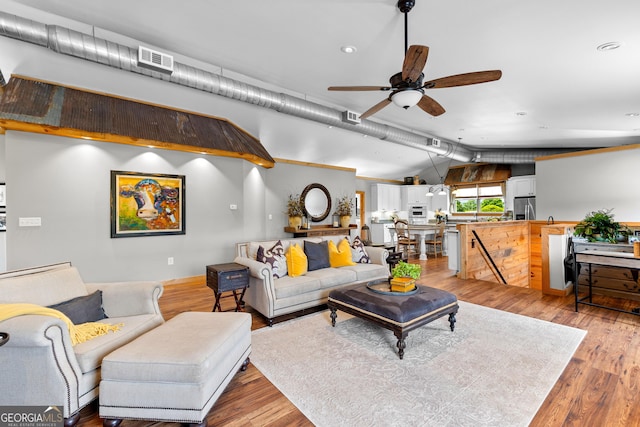 290 Weldon Rd, Fayetteville, GA 30215 - living room with light wood-style floors, vaulted ceiling with beams, a ceiling fan, and visible vents