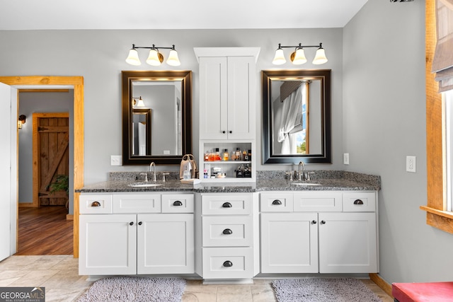 290 Weldon Rd, Fayetteville, GA 30215 - bathroom featuring a sink, baseboards, and double vanity