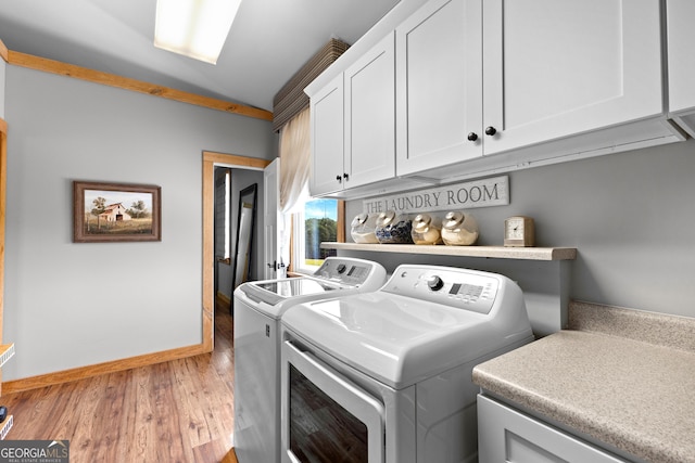 290 Weldon Rd, Fayetteville, GA 30215 - clothes washing area featuring light wood-style floors, baseboards, independent washer and dryer, and cabinet space