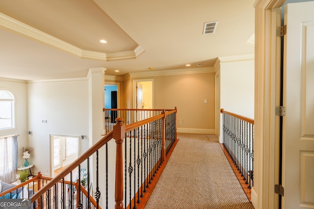 hall with crown molding, visible vents, recessed lighting, carpet flooring, and an upstairs landing