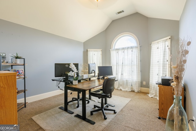 home office featuring visible vents, carpet flooring, baseboards, and high vaulted ceiling