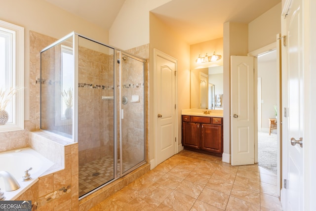 full bathroom featuring vanity, a stall shower, and a garden tub