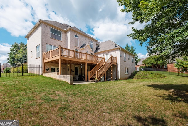 back of house with a yard, brick siding, a wooden deck, and stairs