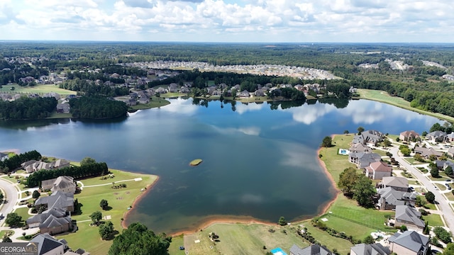bird's eye view with a residential view, a water view, and a wooded view