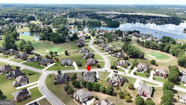 birds eye view of property with a water view and a residential view