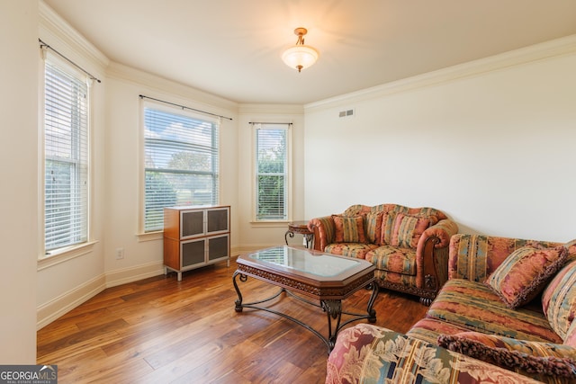 living room featuring visible vents, a healthy amount of sunlight, and wood finished floors