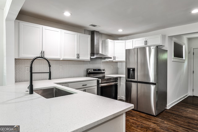 2195 Penelope St NW, Atlanta, GA 30314 - kitchen with stainless steel appliances, wall chimney exhaust hood, light stone counters, dark wood-type flooring, and white cabinetry