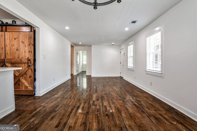 2195 Penelope St NW, Atlanta, GA 30314 - unfurnished living room with a barn door, wood finished floors, and recessed lighting
