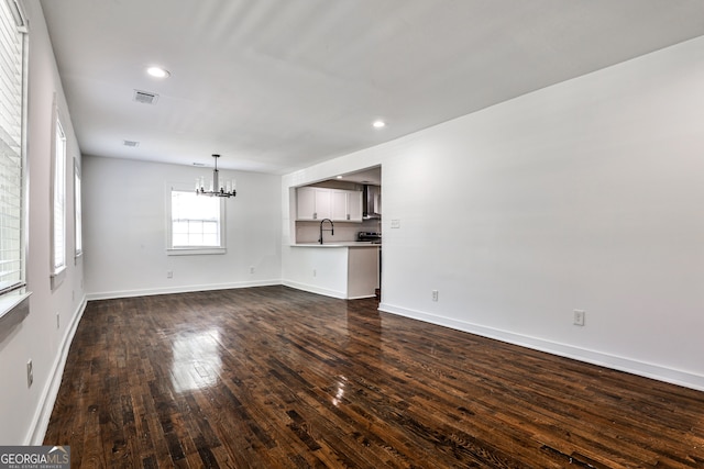 2195 Penelope St NW, Atlanta, GA 30314 - unfurnished living room featuring a chandelier, dark wood finished floors, and recessed lighting
