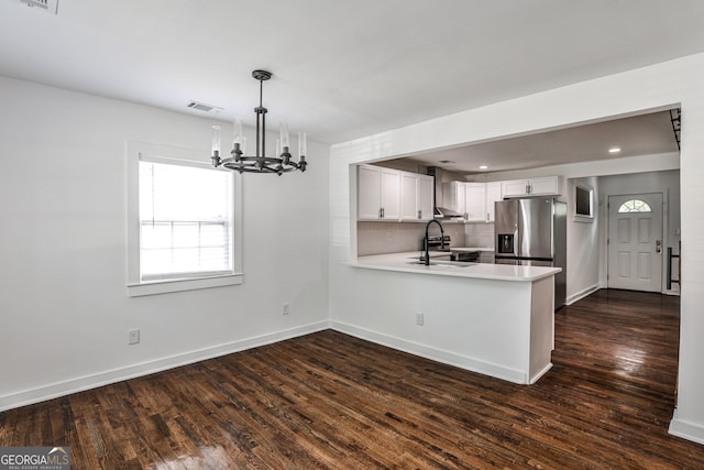 2195 Penelope St NW, Atlanta, GA 30314 - kitchen with stainless steel fridge with ice dispenser, a peninsula, healthy amount of natural light, light countertops, and recessed lighting