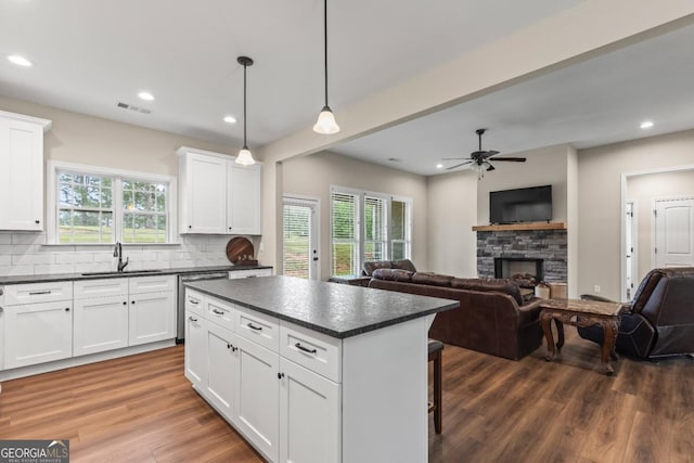 1515 Cabin Creek Trl, Griffin, GA 30223 - kitchen with visible vents, dark countertops, dishwasher, a sink, and open floor plan