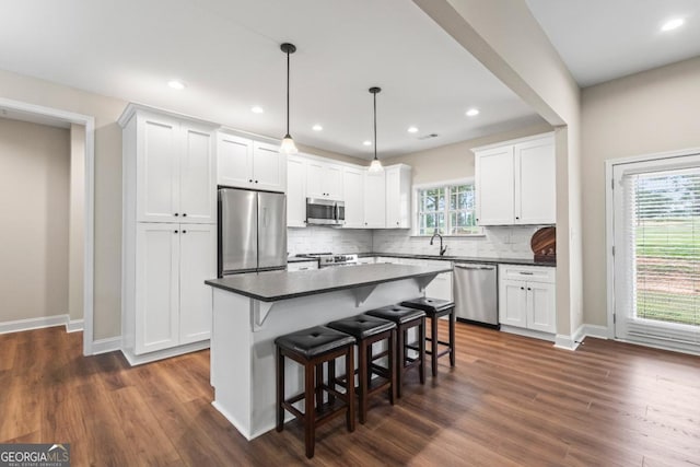 1515 Cabin Creek Trl, Griffin, GA 30223 - kitchen with stainless steel appliances, dark countertops, a sink, and tasteful backsplash