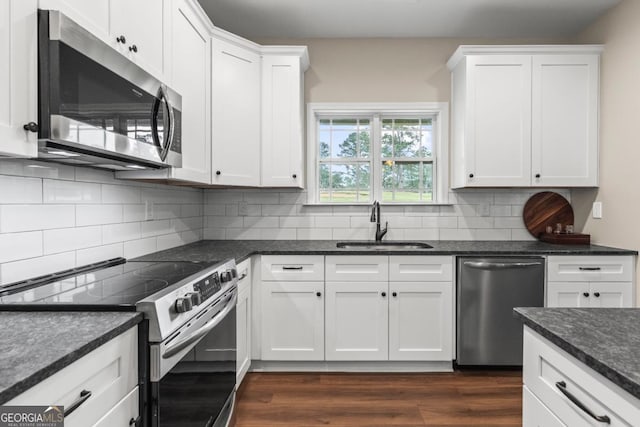 1515 Cabin Creek Trl, Griffin, GA 30223 - kitchen with dark wood-style flooring, white cabinets, a sink, backsplash, and stainless steel appliances