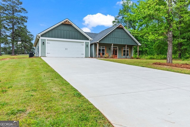 1515 Cabin Creek Trl, Griffin, GA 30223 - craftsman-style home featuring a front lawn, covered porch, board and batten siding, concrete driveway, and an attached garage