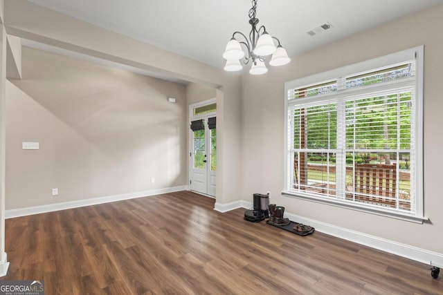 1515 Cabin Creek Trl, Griffin, GA 30223 - unfurnished dining area with baseboards, visible vents, an inviting chandelier, and wood finished floors