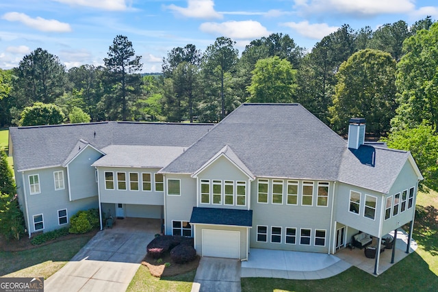 160 Evans Dr, Bogart, GA 30622 - view of front of home with roof with shingles, a garage, driveway, a chimney, and a patio