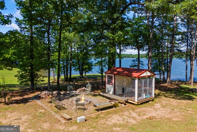 160 Evans Dr, Bogart, GA 30622 - view of yard with a water view, an outbuilding, and an outdoor fire pit