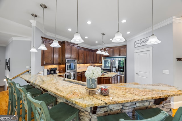 160 Evans Dr, Bogart, GA 30622 - kitchen with a sink, appliances with stainless steel finishes, a kitchen breakfast bar, recessed lighting, and light stone countertops