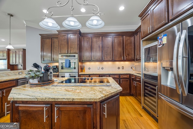 160 Evans Dr, Bogart, GA 30622 - kitchen with appliances with stainless steel finishes, wine cooler, light wood finished floors, a center island, and crown molding