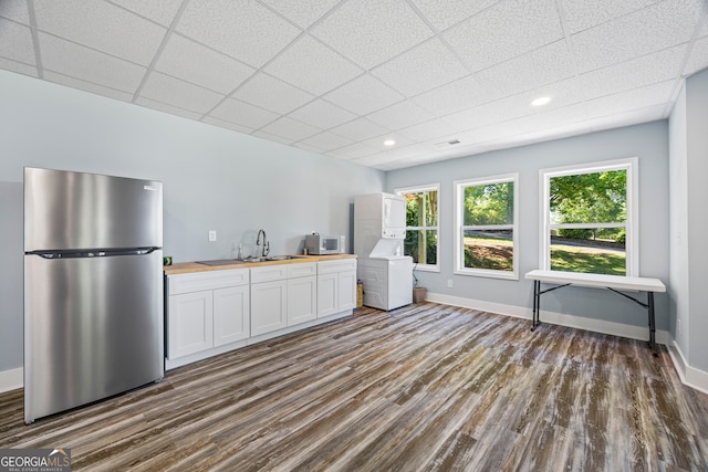 160 Evans Dr, Bogart, GA 30622 - kitchen featuring freestanding refrigerator, butcher block counters, estacked washer and dryer, dark wood-type flooring, and white microwave