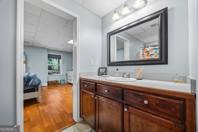 160 Evans Dr, Bogart, GA 30622 - ensuite bathroom featuring a paneled ceiling, vanity, and wood finished floors