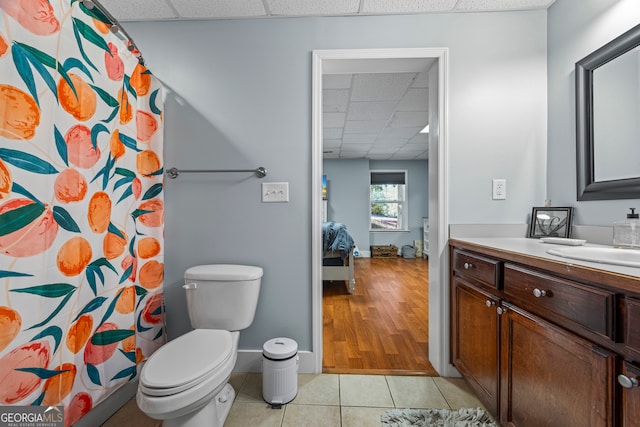160 Evans Dr, Bogart, GA 30622 - bathroom featuring a paneled ceiling, vanity, tile patterned flooring, toilet, and baseboards