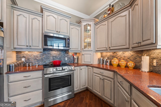 160 Evans Dr, Bogart, GA 30622 - kitchen featuring stainless steel appliances, ornamental molding, dark wood finished floors, decorative backsplash, and glass insert cabinets