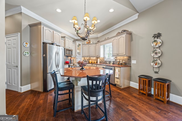 160 Evans Dr, Bogart, GA 30622 - kitchen with stainless steel appliances, ornamental molding, a chandelier, backsplash, and dark wood-style floors