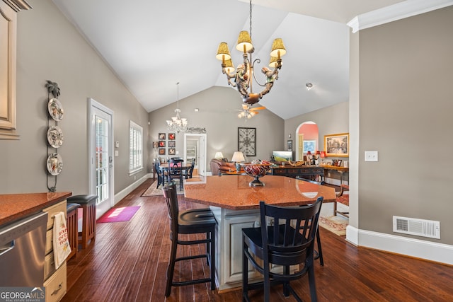 160 Evans Dr, Bogart, GA 30622 - dining space featuring a chandelier, lofted ceiling, dark wood-style floors, and baseboards