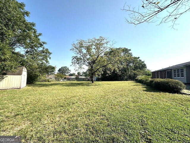 6000 Caribou Dr, Columbus, GA 31907 - view of grassy yard featuring a storage shed and an outbuilding