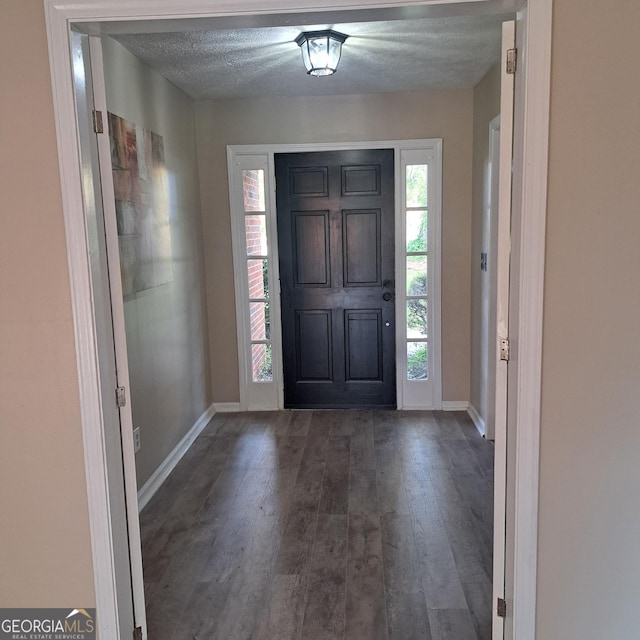 6000 Caribou Dr, Columbus, GA 31907 - entrance foyer featuring dark wood-style flooring, baseboards, and a textured ceiling