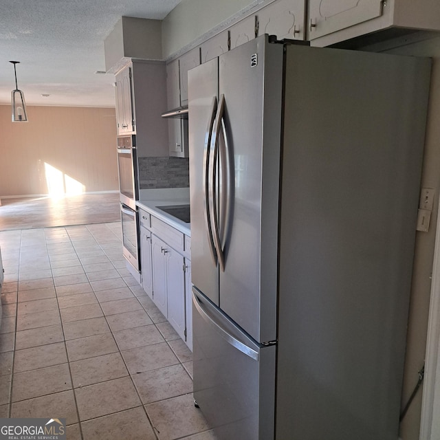 6000 Caribou Dr, Columbus, GA 31907 - kitchen featuring stainless steel appliances, light countertops, light tile patterned floors, a textured ceiling, and white cabinets